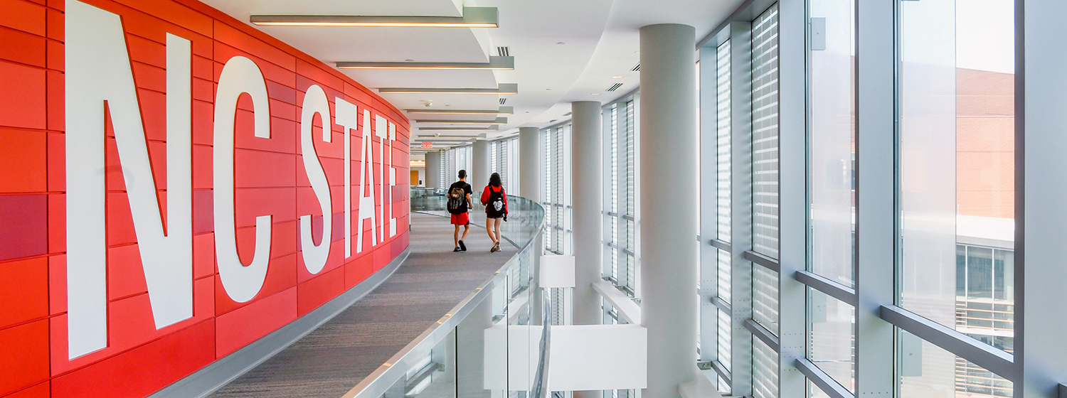 A wall with NC State's logo in Talley Student Union.