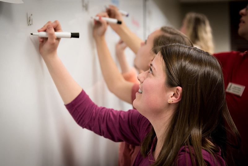 Student writes on whiteboard